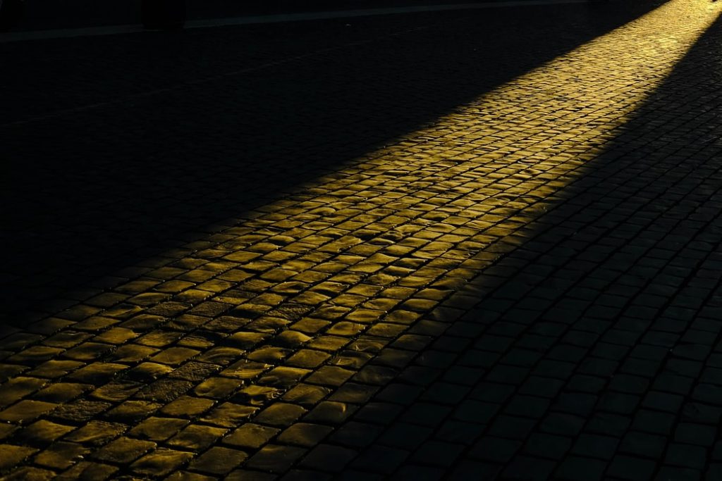 Observing light beaming on the path of cobblestone